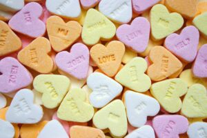 Colorful heart-shaped candies with embossed love messages, perfect for romance themes.